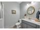 Neutral-colored bathroom featuring a marble vanity and bathtub with a glass door at 220 Venetian Palms Blvd, New Smyrna Beach, FL 32168