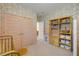 Charming bedroom with pink accents and built-in shelving for storage at 220 Venetian Palms Blvd, New Smyrna Beach, FL 32168