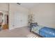Cozy bedroom features neutral walls, white trim, double closet, and a comfortable single bed at 220 Venetian Palms Blvd, New Smyrna Beach, FL 32168