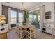 Dining area with wood floors, a modern chandelier, and sliding doors to the outdoor patio at 220 Venetian Palms Blvd, New Smyrna Beach, FL 32168