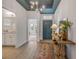 Stylish entryway with a teal ceiling, decorative table, and access to the bathroom at 220 Venetian Palms Blvd, New Smyrna Beach, FL 32168
