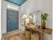 Elegant entryway featuring a rustic table, decorative mirror, and stylish decor at 220 Venetian Palms Blvd, New Smyrna Beach, FL 32168