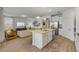 Bright kitchen with stainless steel appliances, a central island, and seamless flow into the adjacent living area at 220 Venetian Palms Blvd, New Smyrna Beach, FL 32168