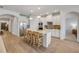 Well-lit kitchen with white cabinets, stainless steel appliances, and an island that offers seating and ample counter space at 220 Venetian Palms Blvd, New Smyrna Beach, FL 32168
