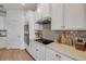 Elegant kitchen with white cabinetry, stainless steel appliances and complementary backsplash at 220 Venetian Palms Blvd, New Smyrna Beach, FL 32168