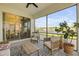Relaxing lanai with comfortable seating, ceiling fan, and stunning water views at 220 Venetian Palms Blvd, New Smyrna Beach, FL 32168