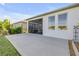 A screened lanai and concrete patio are attached to this home with large backyard and windows at 220 Venetian Palms Blvd, New Smyrna Beach, FL 32168