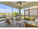 Relaxing lanai with comfortable seating, ceiling fan, and stunning water views at 220 Venetian Palms Blvd, New Smyrna Beach, FL 32168