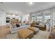 Open-concept living area with modern furniture and natural light, seamlessly connected to the kitchen and outdoor spaces at 220 Venetian Palms Blvd, New Smyrna Beach, FL 32168