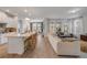 Open concept living space with a modern kitchen, dining area, and comfortable seating at 220 Venetian Palms Blvd, New Smyrna Beach, FL 32168