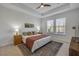 Cozy main bedroom featuring tray ceilings, two windows, and neutral decor at 220 Venetian Palms Blvd, New Smyrna Beach, FL 32168