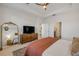Spacious main bedroom with full dresser, tv, and entry to the bathroom at 220 Venetian Palms Blvd, New Smyrna Beach, FL 32168