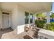 Charming front porch featuring cozy chairs and a welcoming entrance at 220 Venetian Palms Blvd, New Smyrna Beach, FL 32168