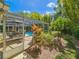 Secluded backyard view featuring a screened pool area and lush landscaping at 2236 Davis Dr, New Smyrna Beach, FL 32168