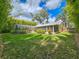 A view of the backyard, including the screened pool and an abundance of bamboo at 2236 Davis Dr, New Smyrna Beach, FL 32168
