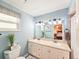 Bathroom features a double sink vanity and a large mirror with a view of the bedroom at 2236 Davis Dr, New Smyrna Beach, FL 32168