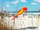 Bright beach scene with a seahorse kite in the foreground on a sunny day at 2236 Davis Dr, New Smyrna Beach, FL 32168