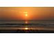 Stunning beach sunset reflecting on the water, with people enjoying the shore at 2236 Davis Dr, New Smyrna Beach, FL 32168
