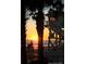 Scenic sunrise on the beach, framed by silhouetted palm trees and a lifeguard tower at 2236 Davis Dr, New Smyrna Beach, FL 32168