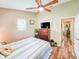 Bedroom includes a ceiling fan, natural lighting, and a dresser with a flat screen TV at 2236 Davis Dr, New Smyrna Beach, FL 32168
