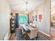 Dining room with a decorative chandelier over a wood table set for six with a dark-blue decorative rug at 2236 Davis Dr, New Smyrna Beach, FL 32168