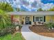 Close up of charming home's front entrance with decorative landscaping and plants at 2236 Davis Dr, New Smyrna Beach, FL 32168