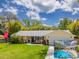 Well-maintained home with a lush lawn, screened pool view and driveway leading to a garage at 2236 Davis Dr, New Smyrna Beach, FL 32168