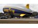 The Goodyear blimp on a tarmac with support vehicles ready for takeoff at 2236 Davis Dr, New Smyrna Beach, FL 32168