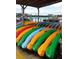 Collection of colorful kayaks neatly stored on a sandy beach near the water at 2236 Davis Dr, New Smyrna Beach, FL 32168