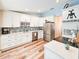 Well lit kitchen with stainless steel appliances, white cabinets, and granite countertops at 2236 Davis Dr, New Smyrna Beach, FL 32168