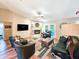 Bright and spacious living room featuring a fireplace, ceiling fan and plenty of seating at 2236 Davis Dr, New Smyrna Beach, FL 32168