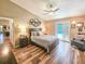 Comfortable bedroom with wood floors and a door that leads out to the pool at 2236 Davis Dr, New Smyrna Beach, FL 32168
