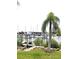 Scenic view of a marina with palm trees, boats, and lush greenery at 2236 Davis Dr, New Smyrna Beach, FL 32168