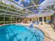 Sparkling in-ground pool with a screened enclosure and spacious patio area at 2236 Davis Dr, New Smyrna Beach, FL 32168