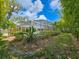 View of screened pool in a beautiful backyard with lush landscaping and bamboo at 2236 Davis Dr, New Smyrna Beach, FL 32168