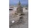Elaborate sand castle on a sunny beach with people relaxing nearby at 2236 Davis Dr, New Smyrna Beach, FL 32168