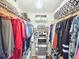 Walk-in closet has plenty of room for storage with shelves and clothing racks at 2236 Davis Dr, New Smyrna Beach, FL 32168