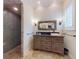 Stylish bathroom featuring stone tile flooring, custom vanity, and a walk-in shower at 2656 Old Smyrna Trl, New Smyrna Beach, FL 32168