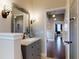 Bathroom featuring custom vanity, mirror, and hardwood floors at 2656 Old Smyrna Trl, New Smyrna Beach, FL 32168