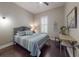 Relaxing bedroom with modern colors, hard wood floor, desk, and accent art at 2656 Old Smyrna Trl, New Smyrna Beach, FL 32168