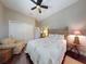 Cozy bedroom features a ceiling fan, closet, and comfortable sitting chair at 2656 Old Smyrna Trl, New Smyrna Beach, FL 32168