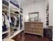 Walk-in closet with custom storage and hardwood floors at 2656 Old Smyrna Trl, New Smyrna Beach, FL 32168
