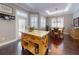 Open-concept kitchen and dining area with hardwood floors, a rustic island, and natural light at 2656 Old Smyrna Trl, New Smyrna Beach, FL 32168