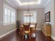 Cozy dining room with hardwood floors, a rustic chandelier, and seating for four at 2656 Old Smyrna Trl, New Smyrna Beach, FL 32168