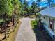 View of the brick driveway and landscape leading up to the home at 2656 Old Smyrna Trl, New Smyrna Beach, FL 32168