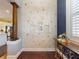 Unique entryway with decorative shell wall, hardwood floors, and a glimpse into the bright kitchen at 2656 Old Smyrna Trl, New Smyrna Beach, FL 32168