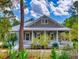 Charming home with a welcoming front porch, white picket fence, and beautifully landscaped front yard at 2656 Old Smyrna Trl, New Smyrna Beach, FL 32168