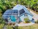 Beautiful exterior view of a house featuring a screened pool and lush greenery at 2656 Old Smyrna Trl, New Smyrna Beach, FL 32168