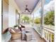 Relaxing front porch with comfortable seating and ceiling fan at 2656 Old Smyrna Trl, New Smyrna Beach, FL 32168