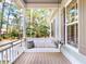 Inviting front porch with hanging swing and outdoor views at 2656 Old Smyrna Trl, New Smyrna Beach, FL 32168